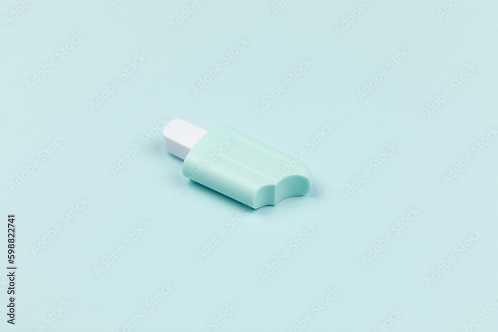 closeup of a popsicle on cyan surface icecream closeup of a popsicle on cyan surface icecream