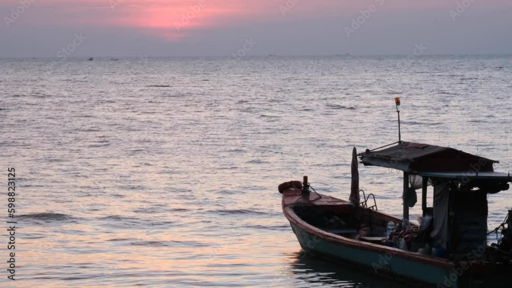 Beautiful sunset on the beach with fishing boat Beautiful sunset on the beach with fishing boat