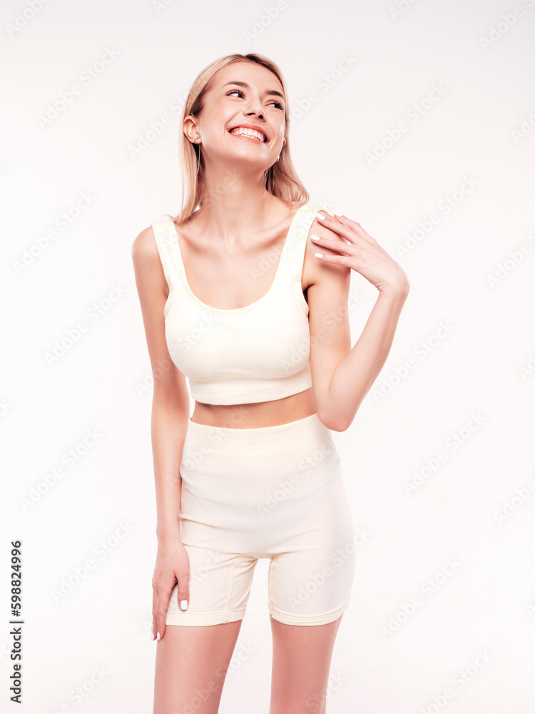 Young beautiful smiling blond female in summer cycling shorts clothes. Sexy carefree woman posing on white background in studio. Positive model having fun indoors. Cheerful and happy. Very slim Young beautiful smiling blond female in summer cycling shorts clothes. Sexy carefree woman posing on white background in studio. Positive model having fun indoors. Cheerful and happy. Very slim