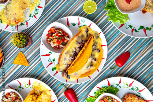 Traditional mexican food. Two tacos with beans, beef and cheese. Colorful Food Table Celebration Delicious Party Meal Concept. 
