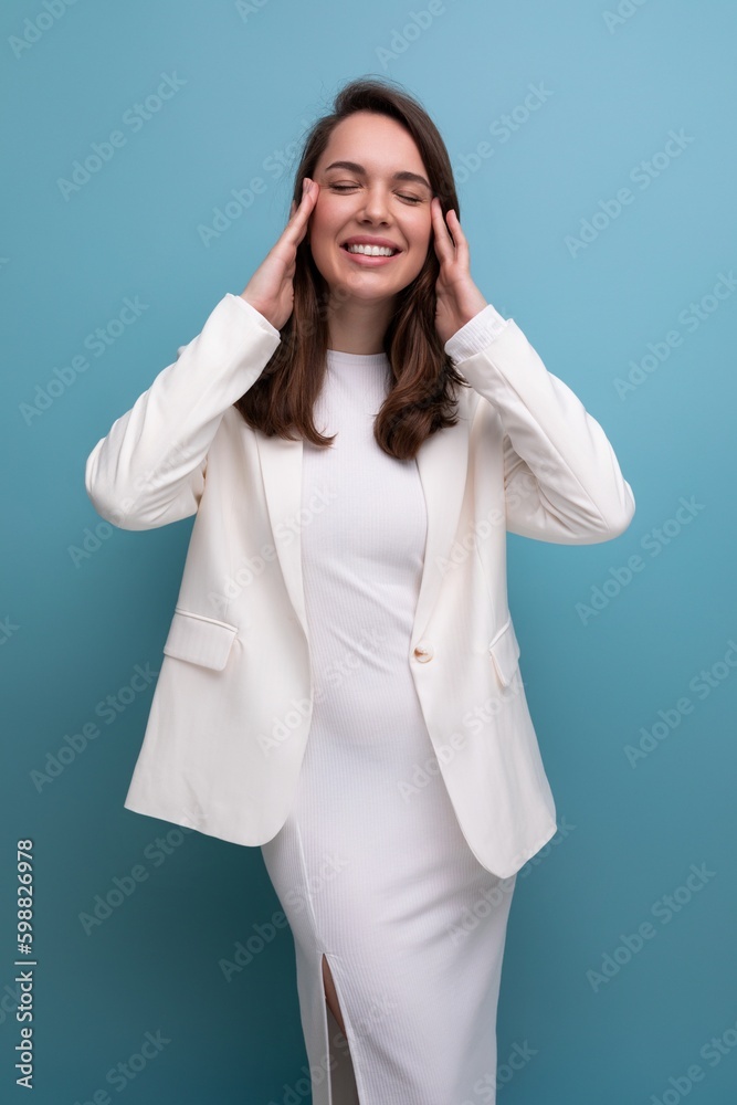 pleasant european brunette young woman in a white dress with cheerful emotions on her face pleasant european brunette young woman in a white dress with cheerful emotions on her face
