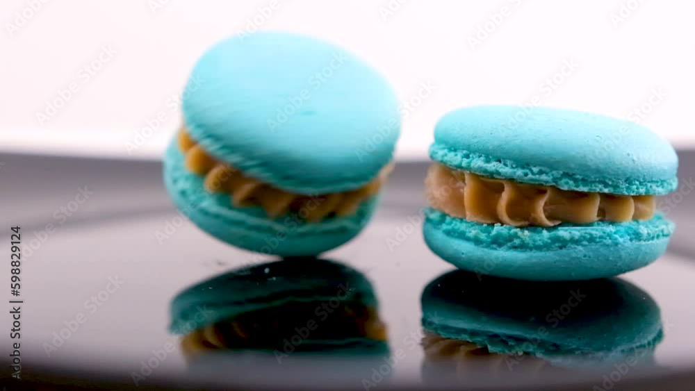 swirling blue macaron lavender or bru cheese flavor on black plate swirling delicious dessert restaurant serving sweetness french dessert lunch chef dish Generative AI swirling blue macaron lavender or bru cheese flavor on black plate swirling delicious dessert restaurant serving sweetness french dessert lunch chef dish Generative AI
