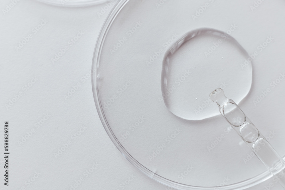 Pipette with Sample of Gels Cosmetic Product in Petri Dish on white background