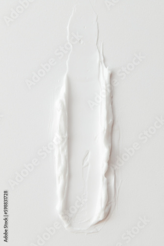 Macro shot of White Cosmetic Cream Smear on White Background. Day cream advertisement