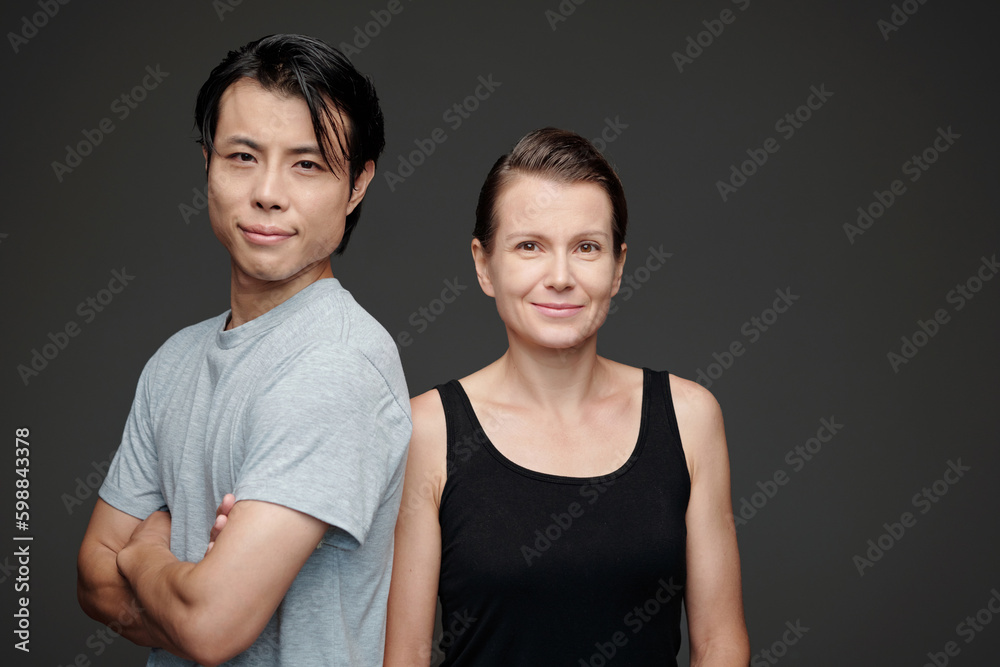 Studio portrait of happy man and woman in casual clothes looking at camera Studio portrait of happy man and woman in casual clothes looking at camera