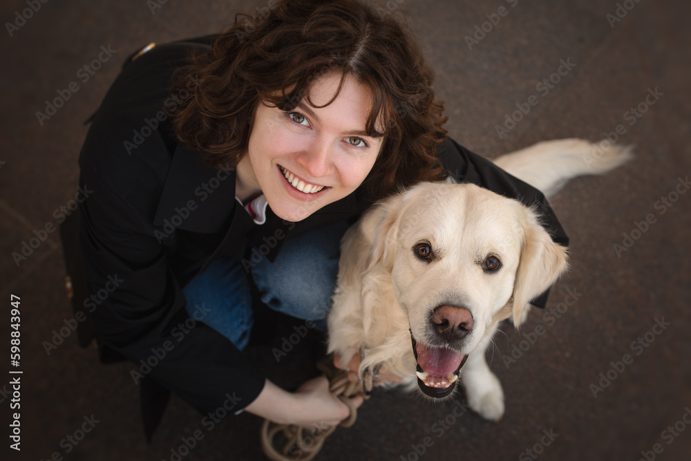 Cute funny girl portrait with her golden dog