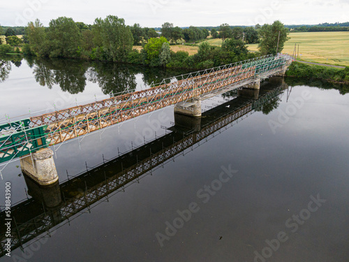 Scaffolding used for maintenance or restoration work on a small bridge over a large river the Cher