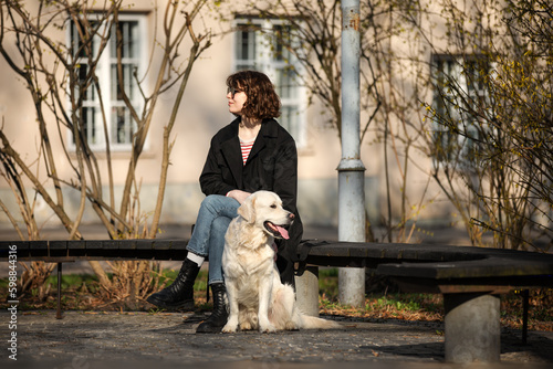 Obraz na płótnie Cute funny girl portrait with her golden dog on street w salonie