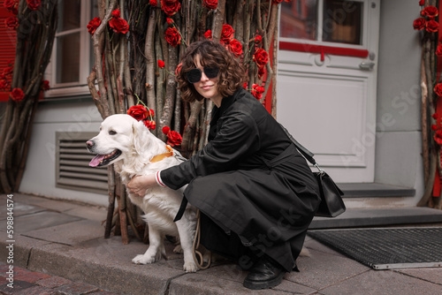 Cute funny girl portrait with her golden dog