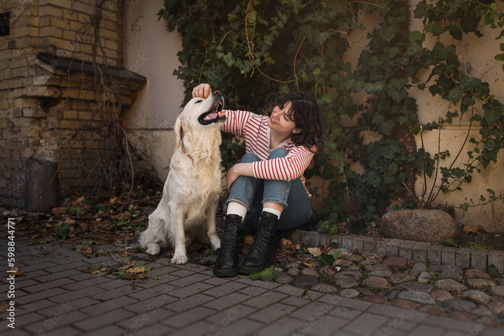 Cute funny girl portrait with her golden dog