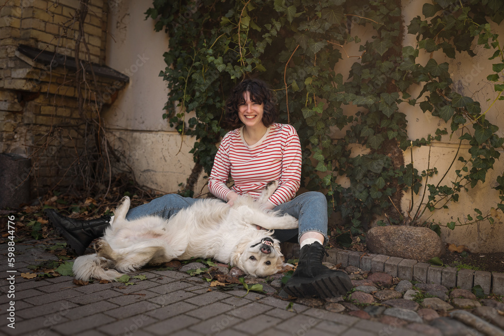 Cute funny girl portrait with her golden dog