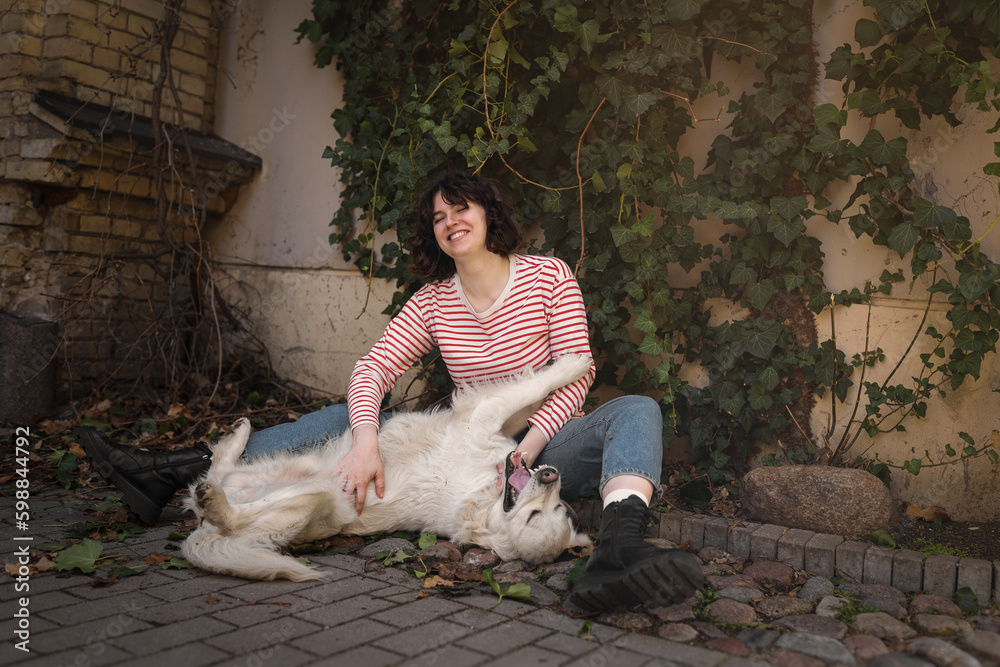 Cute funny girl portrait with her golden dog