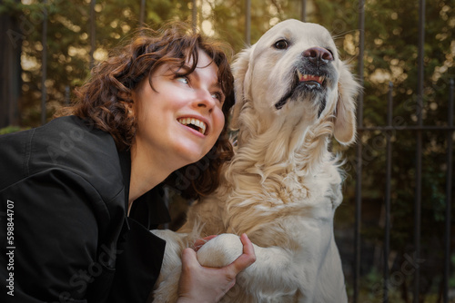 Cute funny girl portrait with her golden dog