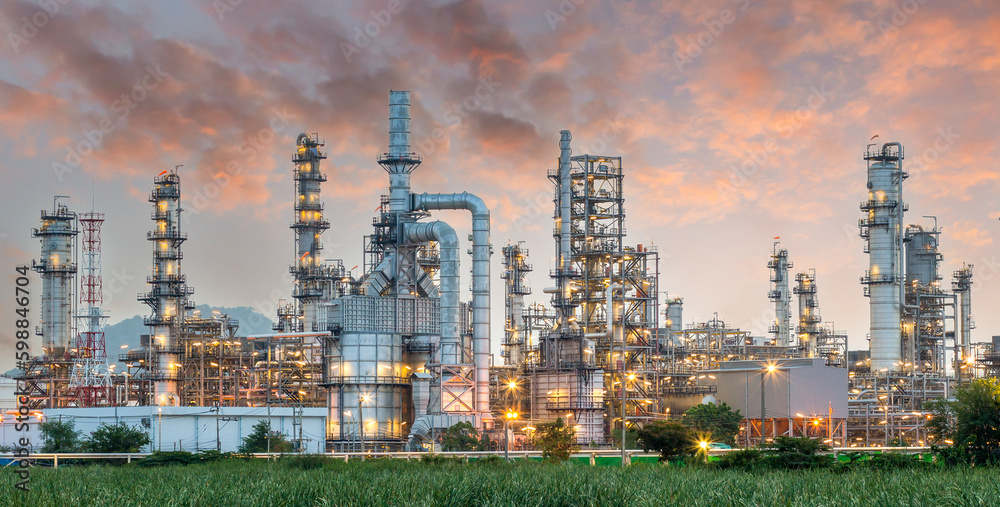 Fototapeta premium Pipeline and pipe rack of petroleum industrial plant with sunset sky background