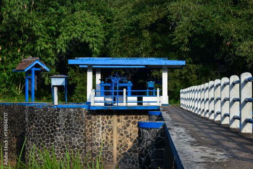 Countryside Sluice next to the river photo