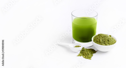 Green powder vegetables for health. Green matcha tea powder in small white bowl on white background. Banner with space for text.