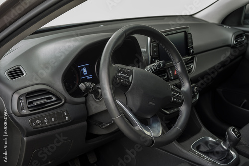 Car interior with a steering wheel, control buttons and manual shift © OttoPles