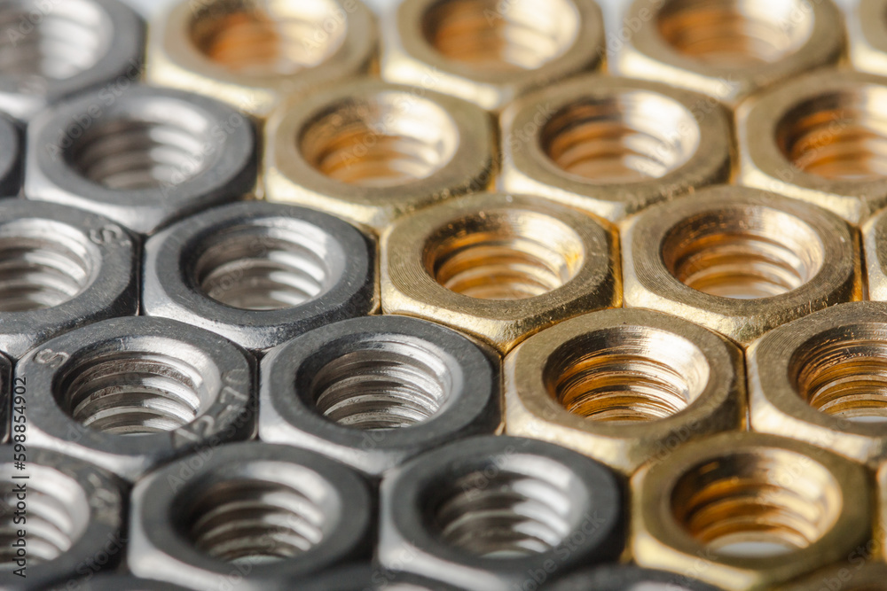Metallic hex nuts layed out in a hexagonal pattern Metallic hex nuts layed out in a hexagonal pattern
