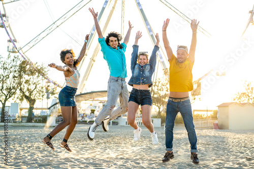 Photography Group of young people jumping on the sand, friends having fun in a beach party,