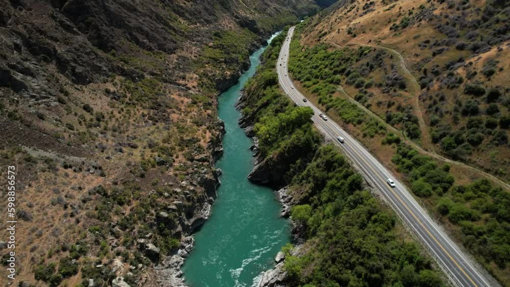 Scenic road by pristine wild Kawarau river, scenery of New Zealand natural landscape. Aerial drone Scenic road by pristine wild Kawarau river, scenery of New Zealand natural landscape. Aerial drone