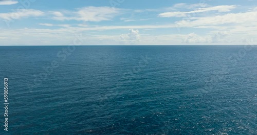 Wallpaper Mural Flying above the deep blue sea with waves and sky with clouds, seascape. Siquijor, Philippines. Torontodigital.ca