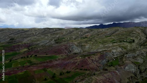 Aerial shot drone flies backwards and to the right over unique red and green circle landscape in Maragua valley photo