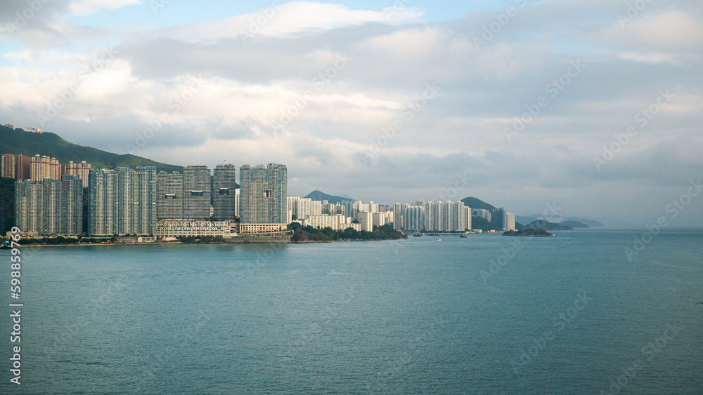 View of Hong Kong Island living and business quarter cityscape with many skyscraper buildings from sea.