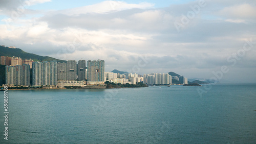 View of Hong Kong Island living and business quarter cityscape with many skyscraper buildings from sea. © Genya