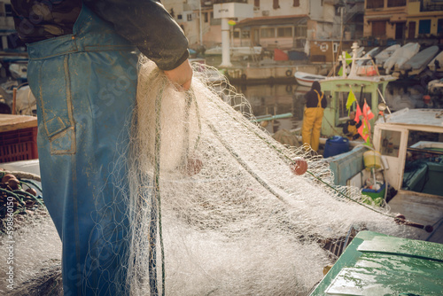 Fisherman with his net on harbor