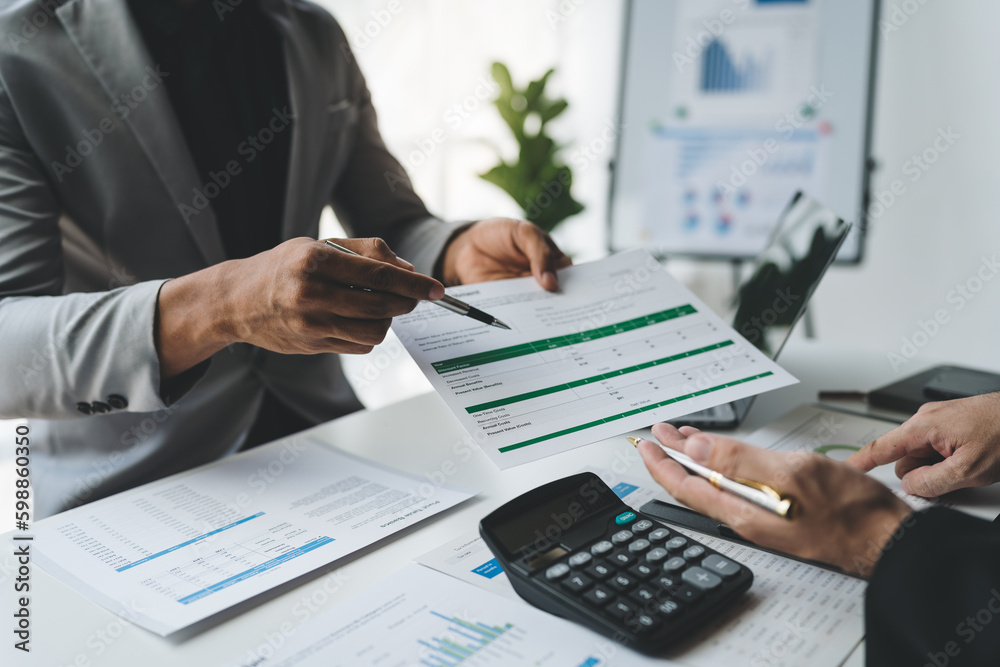 Business people discussing with colleagues plan analyzing data charts. Financial documents and graphs in meetings and successful teamwork.