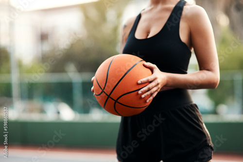 Im ready to play. an unrecognizable sportswoman standing on the court alone and holding a basketball during the day. © Chanelle Malambo/peopleimages.com