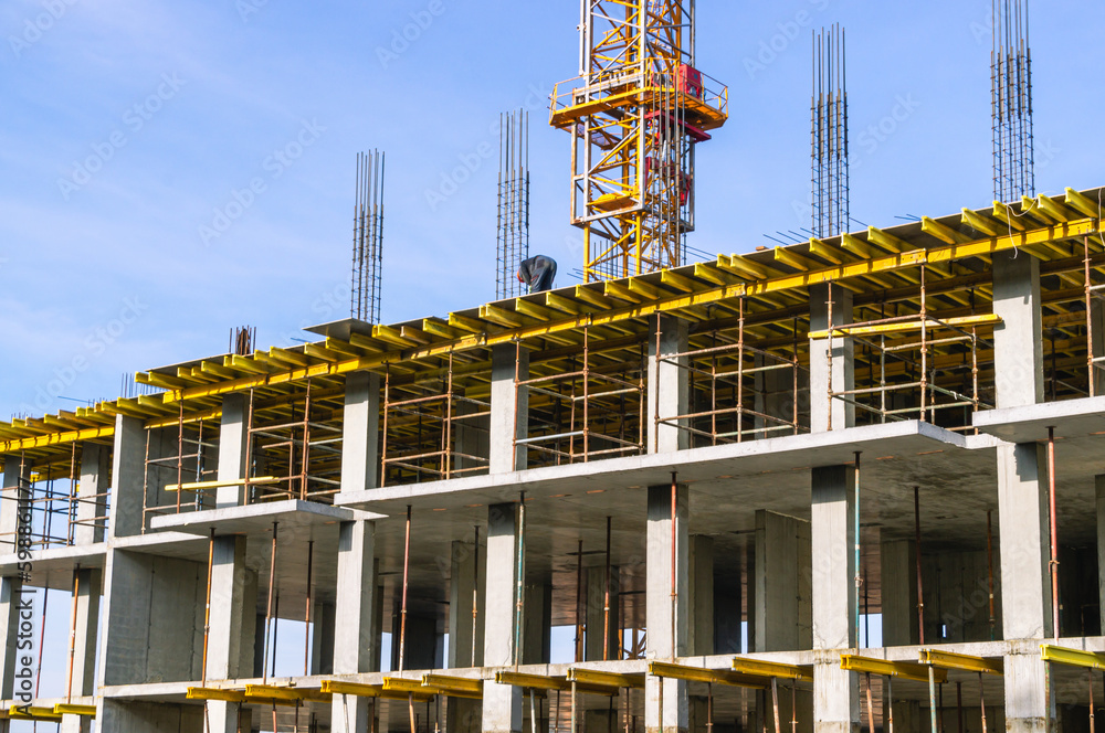 Supports on reinforced concrete piles and a frame during the construction of a multi-storey building. Reinforcement of reinforced concrete columns. The formwork of columns. Construction technology.