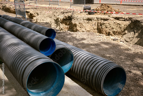 Wallpaper Mural Large plastic corrugated pipes for water supply lie on the street in the city. Torontodigital.ca