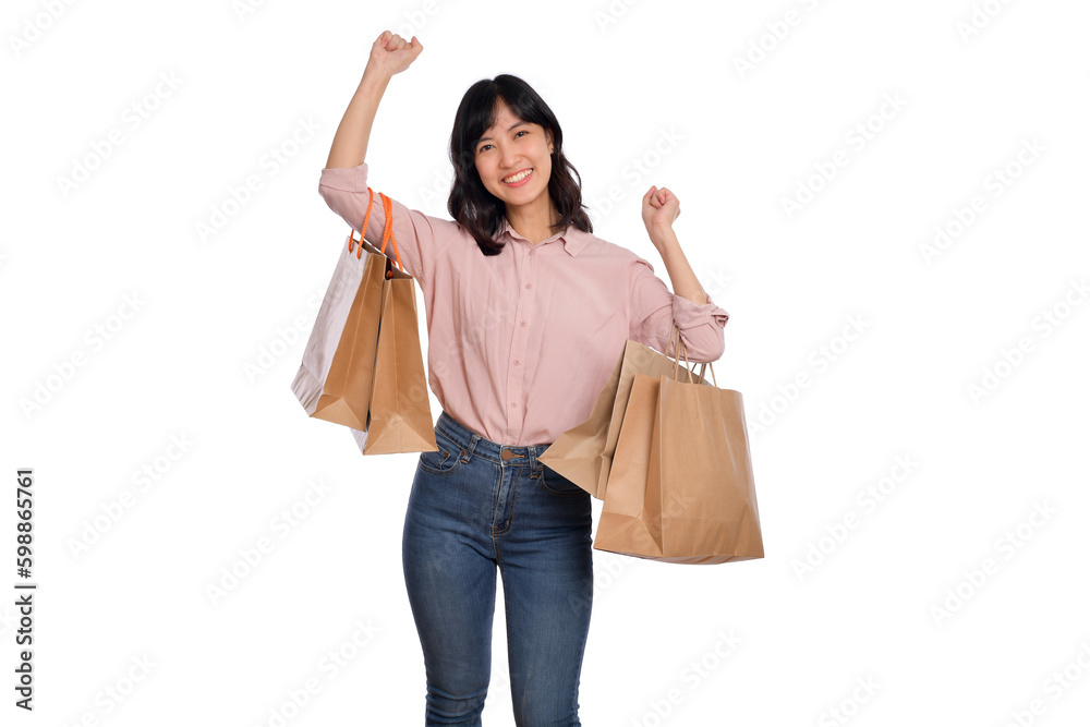Young happy asian woman with casual shirt and denim jeans holding shopping paper bag isolated on white background Young happy asian woman with casual shirt and denim jeans holding shopping paper bag isolated on white background