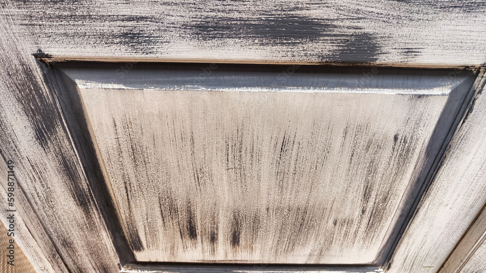 Grey textured door with paint and black frame. Abstract background. Vintage