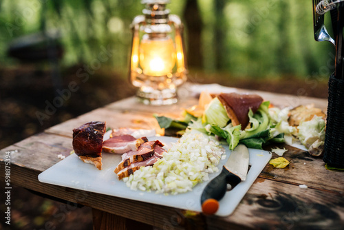Chopped onion and bacon on table outdoors photo