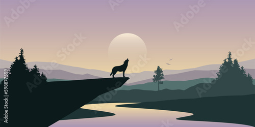 Photo wolf howls to the full moon in forest on river mountain landscape