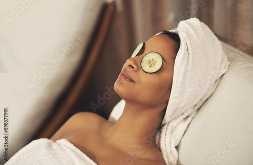 Indulging in some much-needed me time. a woman relaxing in a spa with cucumber slices on her eyes.