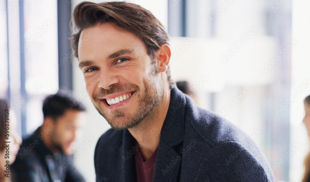 You have to stay determined in order to reach your goals. Portrait of a young businessman sitting in an office with his colleagues in the background. You have to stay determined in order to reach your goals. Portrait of a young businessman sitting in an office with his colleagues in the background.