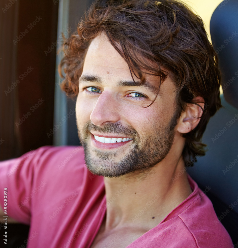 Carefree on the road. A young man enjoying his vacation road trip with a smile. Carefree on the road. A young man enjoying his vacation road trip with a smile.