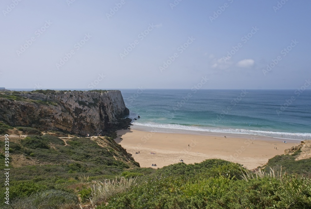 Wonderful landscapes in Portugal. Scenic coastline in Sagres. Praia do Beliche view from the cliff. Wavy sea. Rocky skerries. Sunny spring day. Selective focus