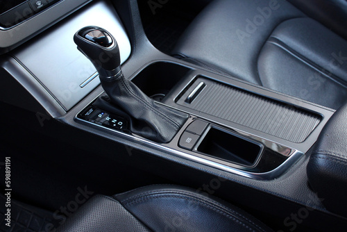 Selector automatic transmission with leather in the interior of a modern car. Close up detail of gear knob. Black leather car interior close up. © Best Auto Photo