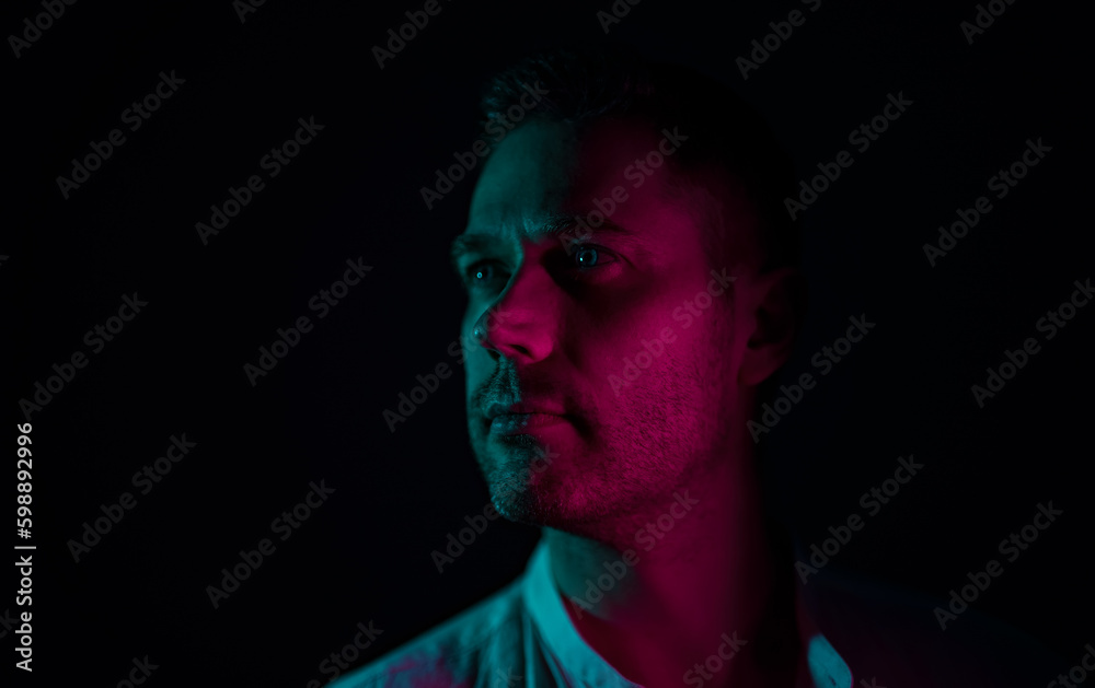 Portrait of a handsome unshaven middle-aged man. In neon light. Portrait of a handsome unshaven middle-aged man. In neon light.