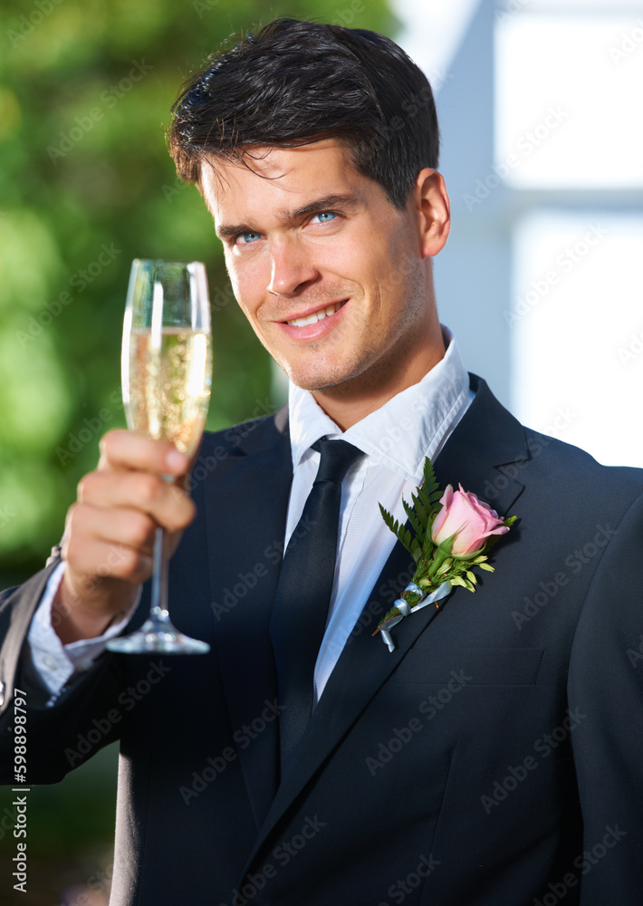 Toasting to a great day. Portrait of a handsome young groom toasting the camera with champagne. Toasting to a great day. Portrait of a handsome young groom toasting the camera with champagne.