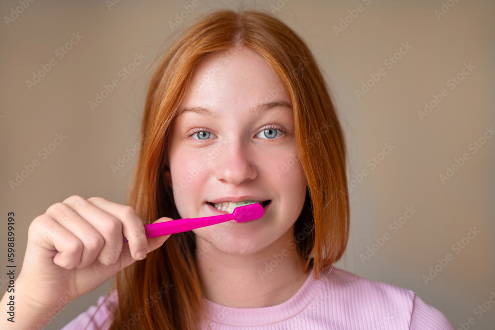 Teenage girl brushing teeth in bathroom at home. Teenage girl brushing teeth in bathroom at home.