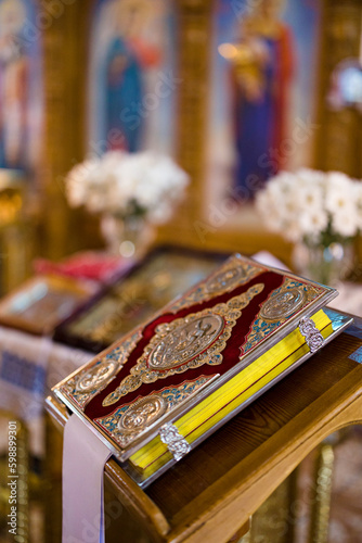 Closeup view to Holy bible on lectern during a wedding ceremony in an Orthodox church.