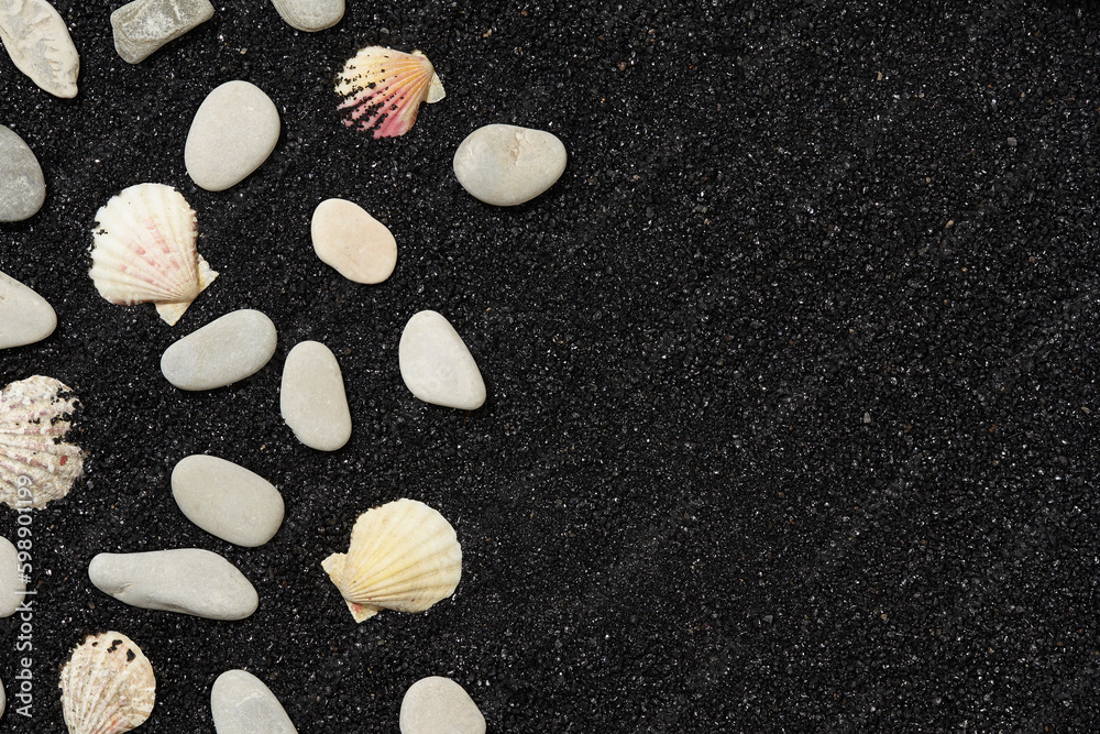Fototapeta premium Black sand with sea shells and pebbles