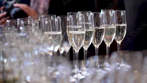 Kyiv, Ukraine - May 2023: Many glasses of champagne. Champagne is poured into glasses during a corporate party.