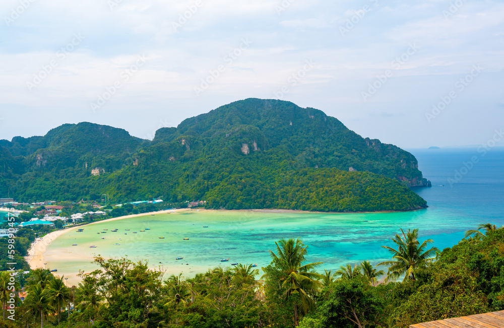 Aerial view of Ko Phi Phi islands, Thailand. Lookout from the viewpoint to tropical island, beach and ocean with long tail boats. Exotic nature, summer weather. Aerial view of Ko Phi Phi islands, Thailand. Lookout from the viewpoint to tropical island, beach and ocean with long tail boats. Exotic nature, summer weather.