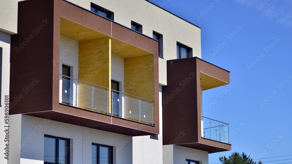 Modern apartment buildings on a sunny day with a blue sky. Facade of a modern apartment building. Contemporary residential building exterior in the daylight. 